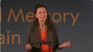 Nobel Prize-winning neuroscientist and HVS Image user May-Britt Moser delivering a lecture on 'Space, Time, and Memory in the Brain,' discussing the discovery of grid cells and how the brain encodes spatial orientation and memory.